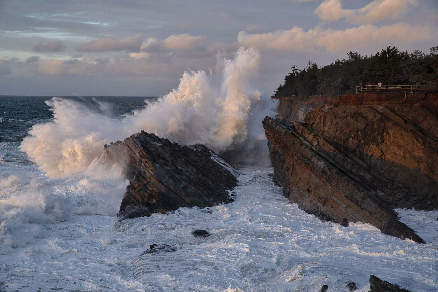 Huge ocean waves crash on the cliffs at Shore Acres State Park in Oregon