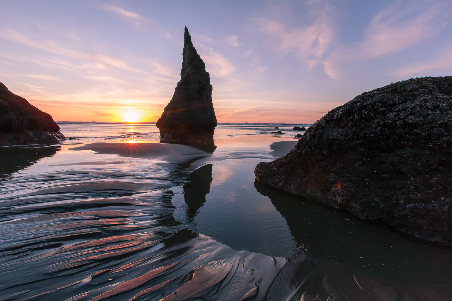 Rock formations at Bandon Beach in Oregon at sunset with a low tide