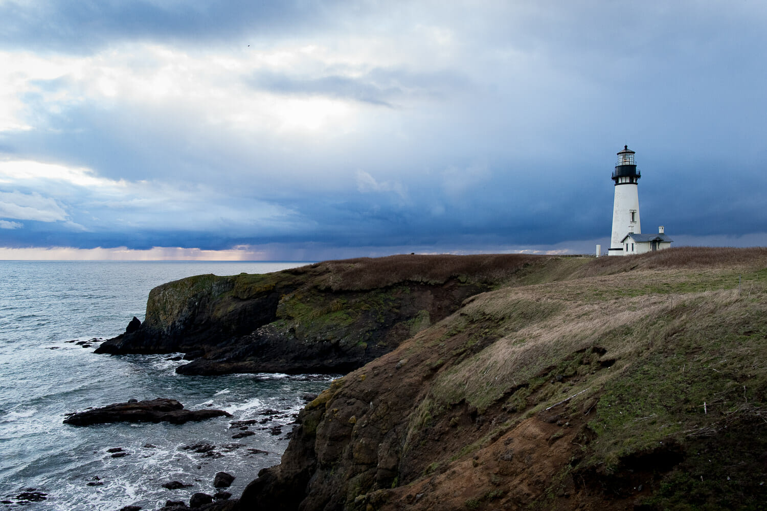 Oregon's Yaquina Head lighthouse on the cliff above a stormy ocean