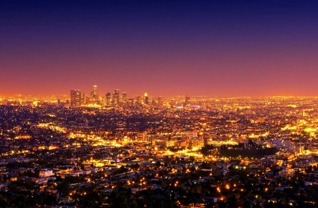 The brightly lit los angeles downtown and surrounding area at sunset