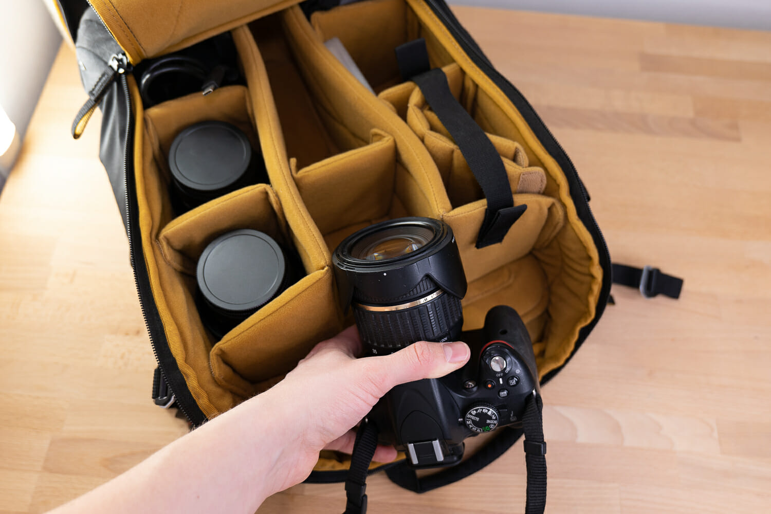 Placing a camera into a camera bag with multiple lenses