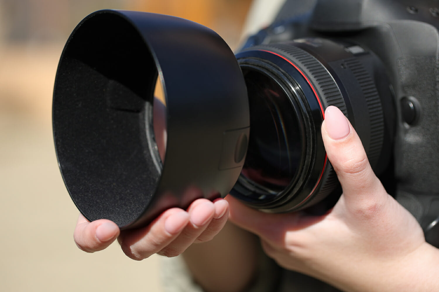 Attaching a camera lens hood to a lens