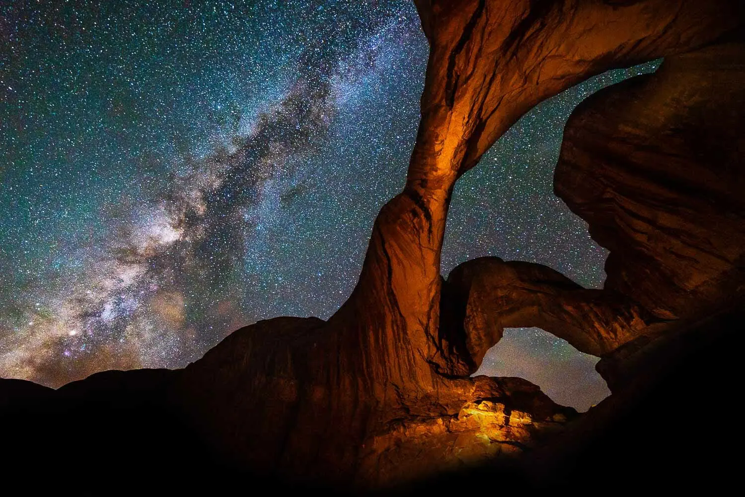 Milky Way shines over red rock natural arches